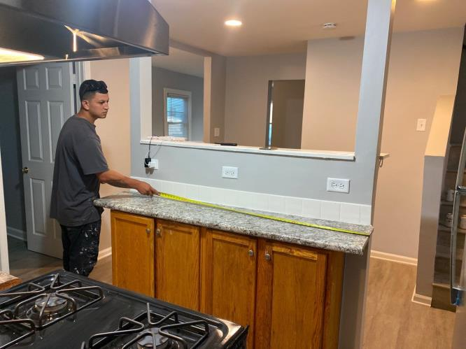 Worker installing or repairing new lock handyman repair the door lock